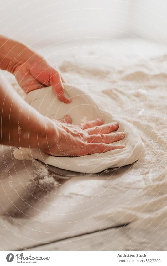 Preparing pizza dough in a faceless pizzeria shot preparation chef anonymous cropped shaping pressing kitchen cooking bake food hand finger work process flour