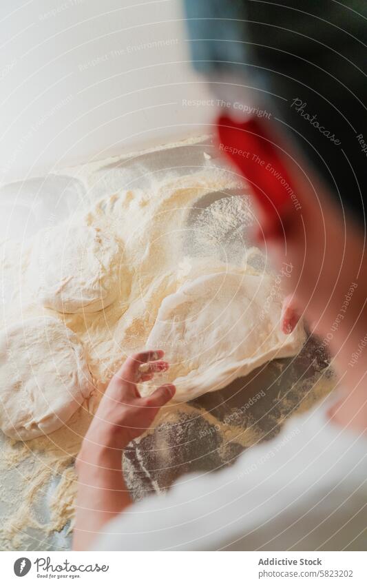 Stretching Pizza Dough in a Pizzeria Kitchen chef pizza dough stretching pizzeria kitchen cooking baking making preparation food cuisine italian work flour