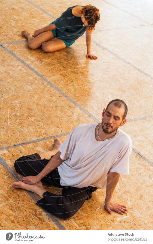 Participants engaging in a holistic dance ceremony participant individual serene connected movement wooden floor male female spiritual practice mindful