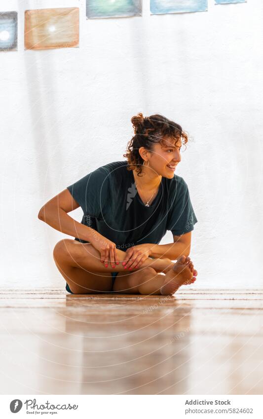 Serene Dancer Preparing for Holistic Ceremony woman dancer holistic ceremony stretching wooden floor preparation expression happy sitting health wellness