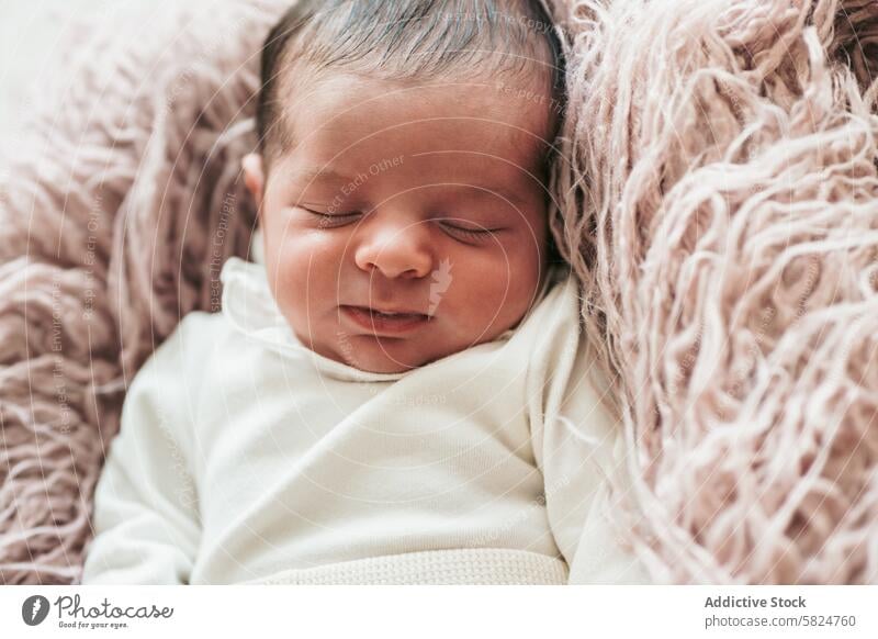 Peaceful newborn sleeping soundly in a cozy setup baby peaceful serene infant blanket soft texture innocence slumber child nap rest calm tranquility warmth snug