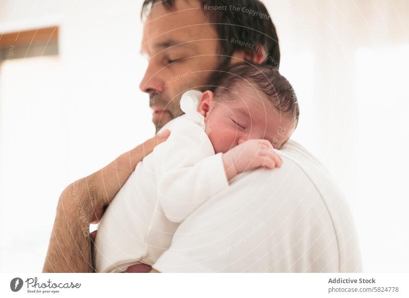 Newborn Baby Sleeping Peacefully in Father's Embrace baby father newborn sleeping embrace tender soft white infant parenthood family love care male bonding