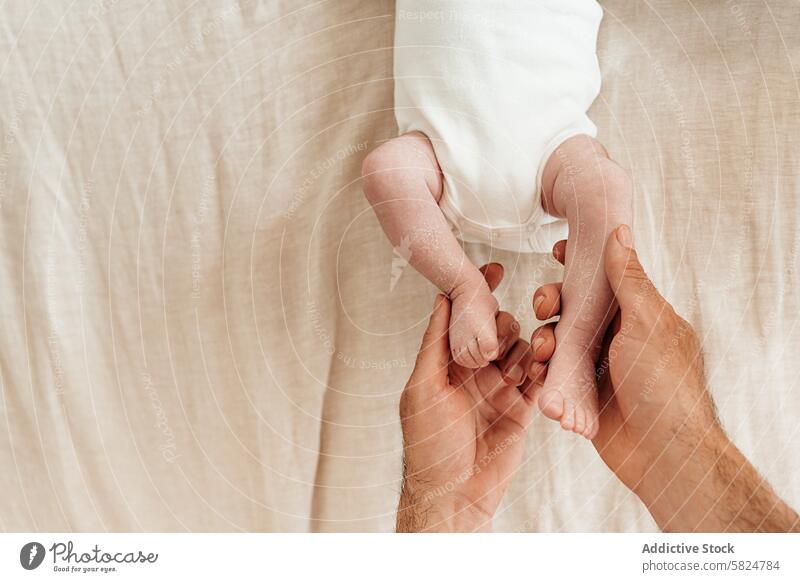 Gentle hands holding a baby's feet on a soft background care tender cradle linen backdrop natural barefoot gentle touch delicate infant nurture love protect