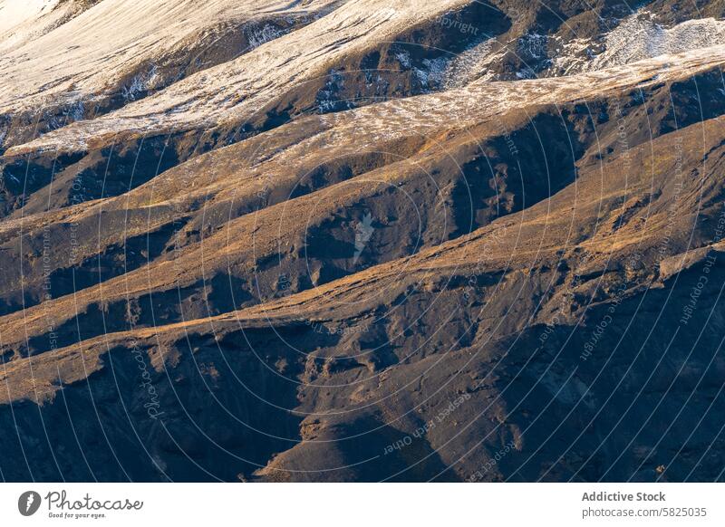 Icelandic Highlands: Textured Terrain and Snow Patches iceland highland texture terrain snow sunlight rugged mountain slope nature outdoor landscape scenic wild
