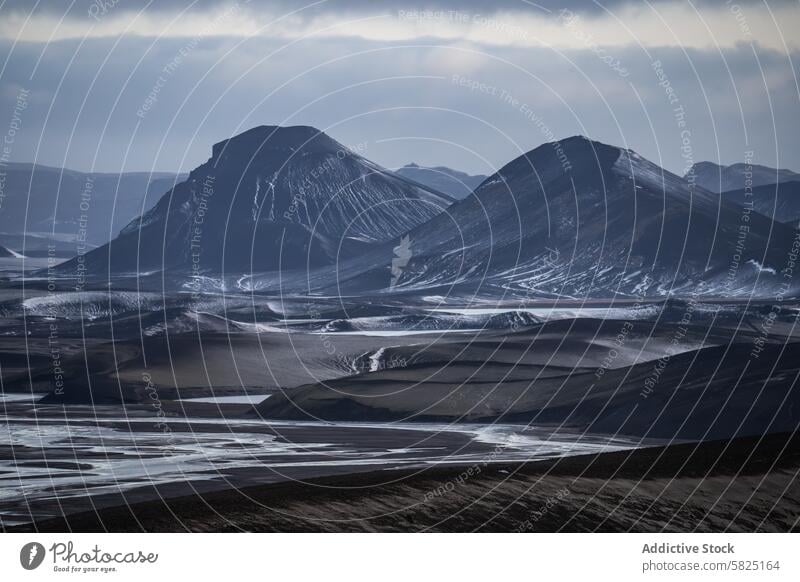 Majestic volcanic peaks in the Icelandic Highlands iceland highlands landscape dramatic moody sky awe-inspiring terrain undulating majestic nature scenic