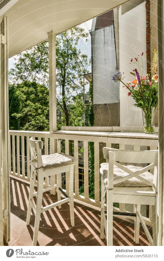 Cozy balcony with green view at Balthasar Floriszstraat 16-2 greenery white chair table flowers outdoor refreshment cozy apartment balthasar floriszstraat