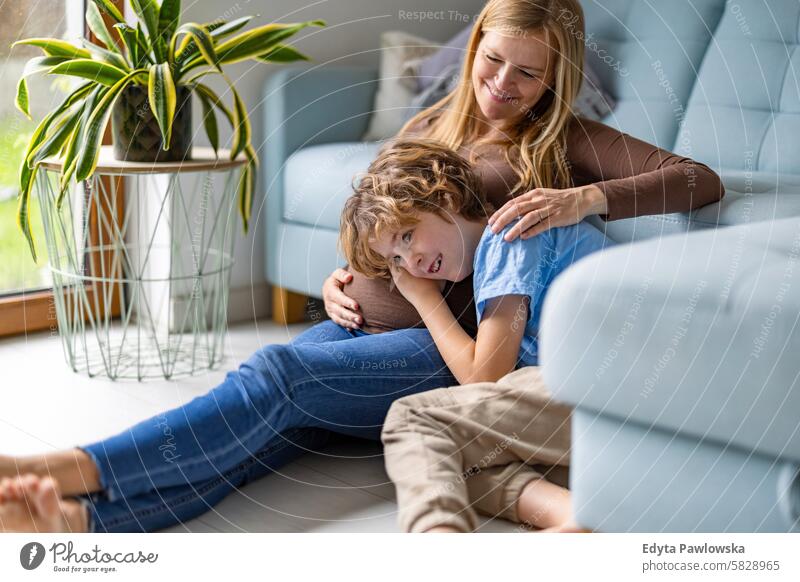 Little boy with his pregnant mother at home pregnancy adult anticipation awaiting baby belly birth body care caucasian child expectant expecting expectation