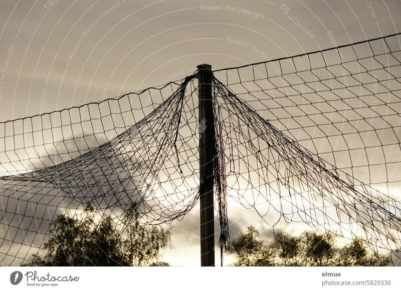 Open, high-hanging ball net in front of dark clouds Ball catching net Sports facility Net Sombre mood Ball sport Sporting grounds Leisure and hobbies