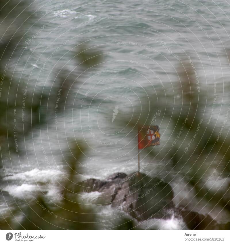 proverbial | hanging his flag in the wind Flag Wind Gale stormy Judder Disheveled wind-blown Ocean windy Blow Cliff Rock coast bank Stone White crest Waves Foam