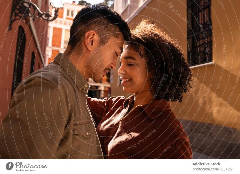 Romantic multiethnic couple bonding on a sunny street in Madrid love romance multicultural interracial happiness smile relationship chinese hispanic