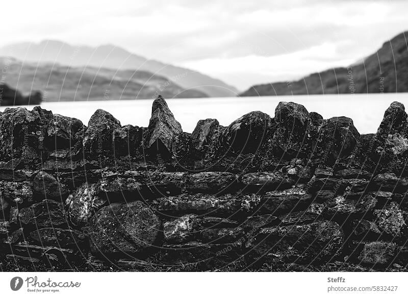 a stone wall on the shore of the Scottish lake Loch Lomond Stone wall Scotland Scottish Sea Lake Wall (barrier) Traces of fomer wall Lakeside bank
