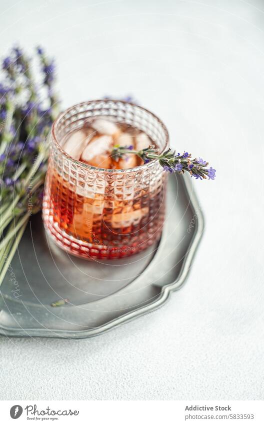 Lavender-infused cognac cocktail served in a textured glass drink lavender tray metal refreshing alcohol beverage bar mixology sophisticated elegant aroma