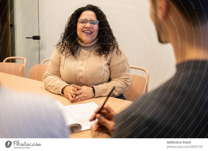 Collaborative work session at a coworking space office teamwork meeting collaboration friends laughing smile professional interaction coworker table discussion