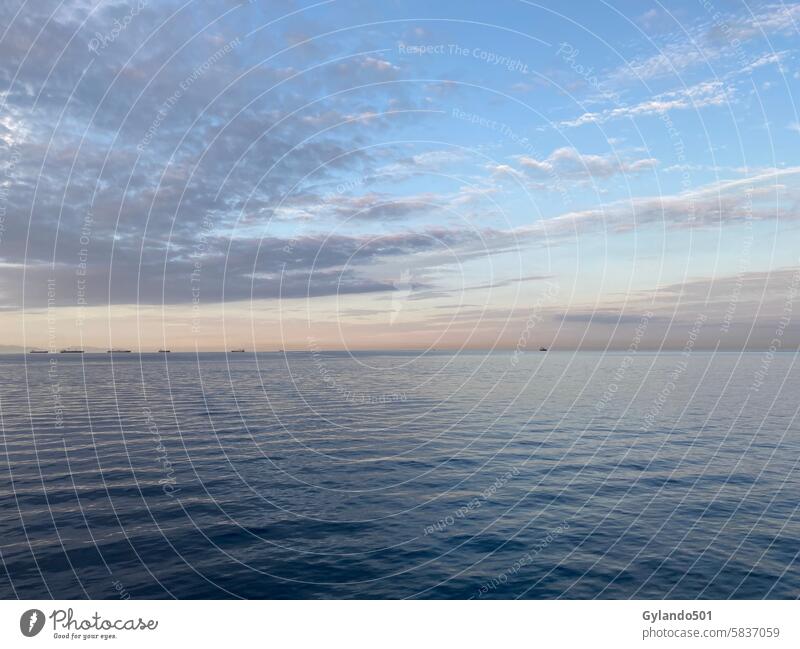 Mediterranean Sea under the evening sky with a row of freighters Mediterranean sea Sunset Dusk Twilight Ocean Cargo-ship ships Waves Clouds Evening Sky Water