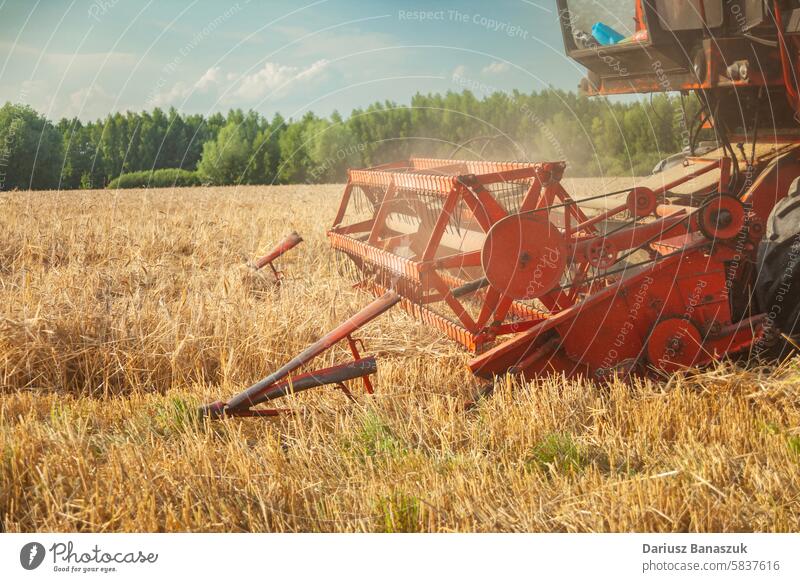 A combine harvester mowing low, poor grain yields field wheat working machinery summer rural outdoors harvesting agriculture farm crop - plant no people tractor