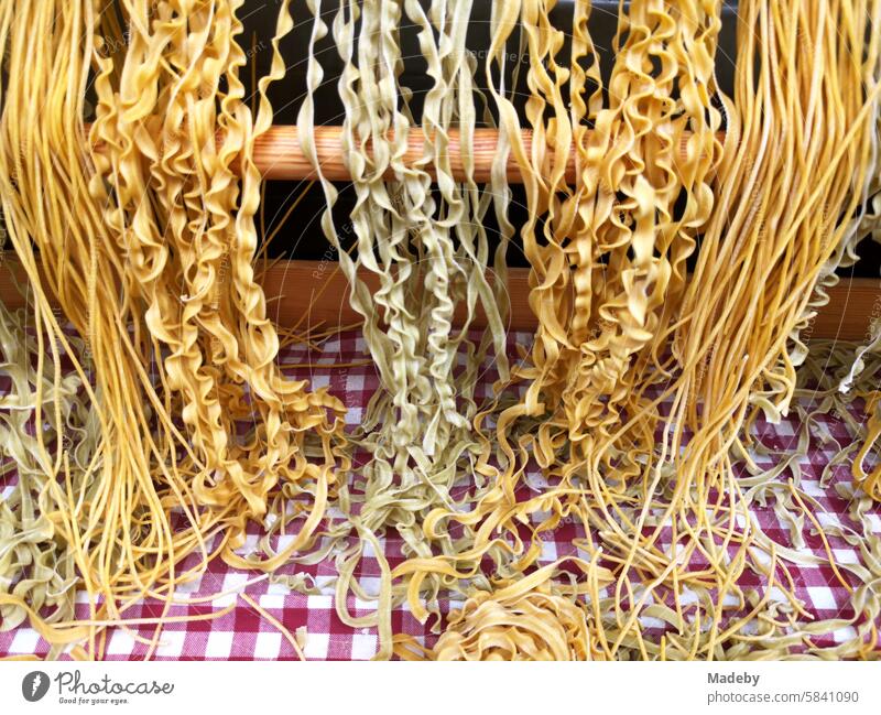 Fresh pasta in different varieties with a checkered tablecloth in the window of a gourmet store on Istiklal Caddesi in the Beyoglu district of Istanbul on the Bosphorus in Turkey