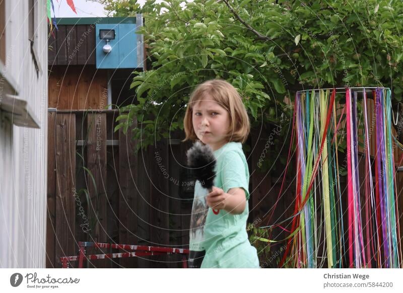Girl looks grimly into the camera with a hand broom Ferocious Evil Anger Human being Face Looking Feminine Nature out Garden Colour photo