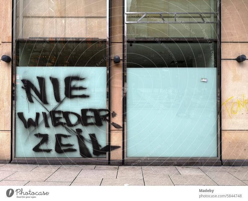 Never again Zeil - Graffiti on the window of a vacant store and business in the shopping street and pedestrian zone Zeil in the city and city center of Frankfurt am Main in Hesse