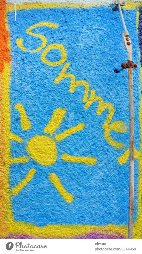 Colorful graffiti with a yellow sun and the text Summer on a house wall Graffiti variegated Sun Street art Youth culture Daub Mural painting Lifestyle