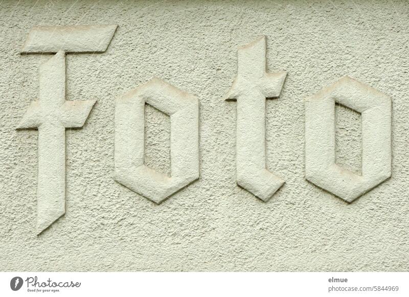 lettering made of stone on a gray house wall - Photo - photo Masonry Image Advertising visualization Photography Photo app Take a photo film development movie