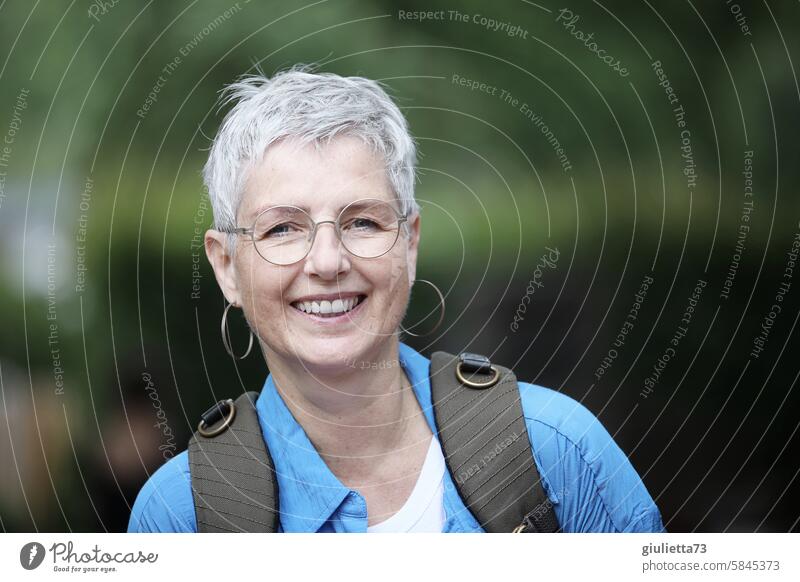 UT Leipzig - cheerful to cloudy | Portrait of a happy, laughing woman with short, gray hair outside in nature portrait Woman Face Looking Feminine Human being