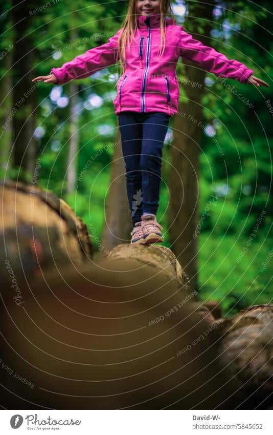 Child balancing over a tree trunk in nature balance Playing Nature Forest Balance Concentrate fun out Girl Movement Happiness Joie de vivre (Vitality) Infancy