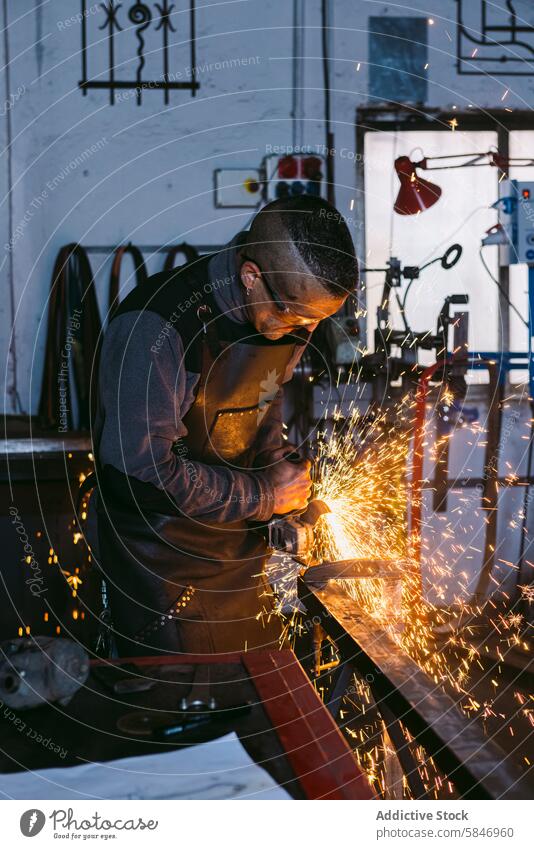 Blacksmith working with grinder in workshop blacksmith male grinding metal sparks skilled craftsmanship labor profession industry protective apron