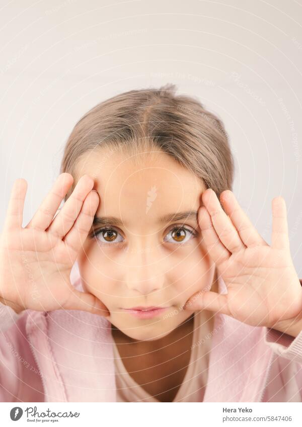 portrait of girl with her hands framing her face. Large and expressive eyes Face Portrait photograph Feminine Interior shot Eyes Looking into the camera