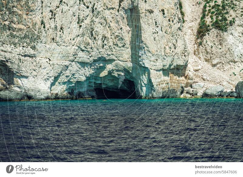 Natural cave formation on a rocky hill stretching to the sea in Zakynthos Ionian Island Greece. zakynthos island ionian sea greece serene seascape