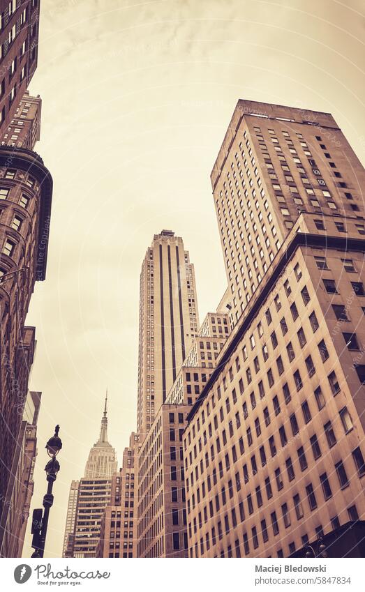 New York skyscrapers, color toning applied, USA. NYC city new york building office manhattan wall business retro vintage financial district usa look up filtered