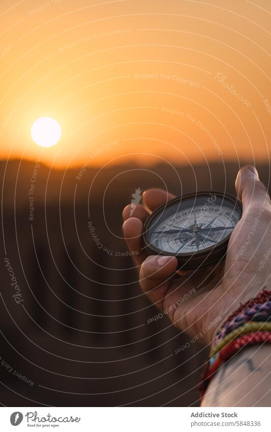 Compass in hand at sunset on an Oman adventure compass oman travel exploration nature desert landscape journey direction navigation sky warm dusk golden hour