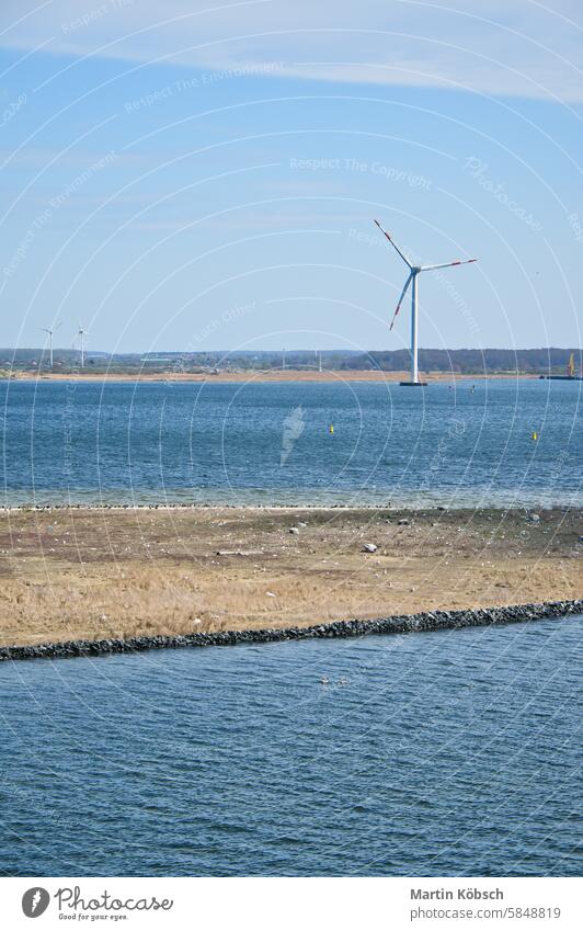 Offshore wind turbine in the sea, on the coast. Green energy of the future. Energy wind power clean offshore industry ecology rotor electricity green sun