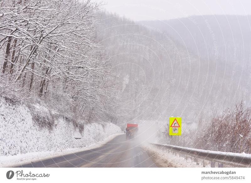 Snow landscape and winding road. View from driver seat. adventure asphalt autobahn blizzard cold covering danger driving frost frozen hill ice journey nature