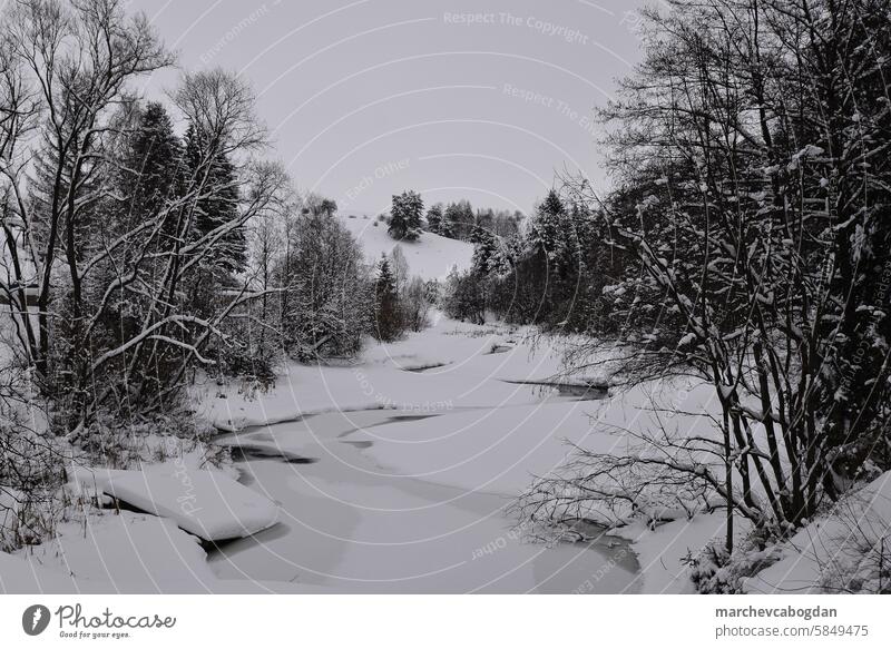 frozen river in winter season calm clear cold forest frost ice icy landscape mountain nature outdoor outdoors rural scene scenery scenic snow snowy stream
