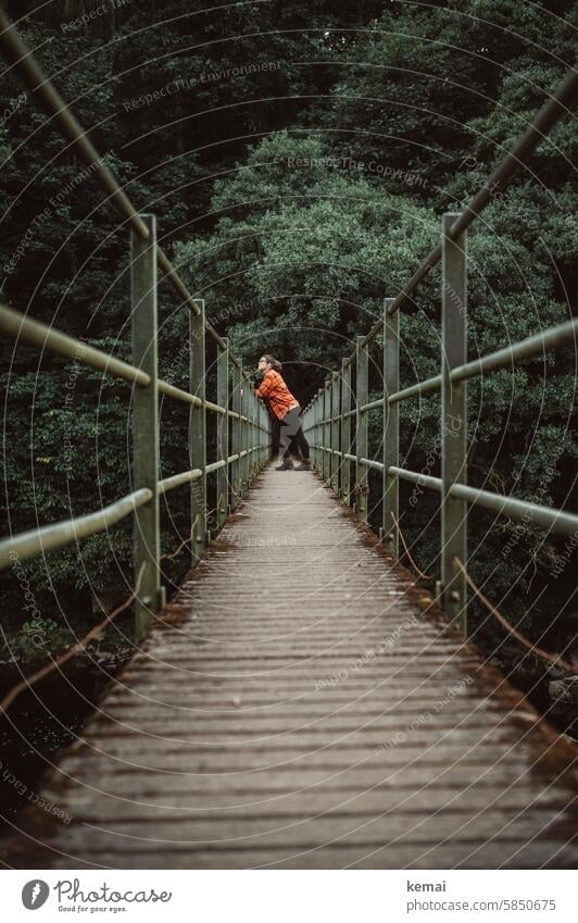 Waiting on the bridge Bridge Wooden bridge Woman Human being Stand look by oneself Lonely Loneliness tranquillity Support rail Steel Hiking Break