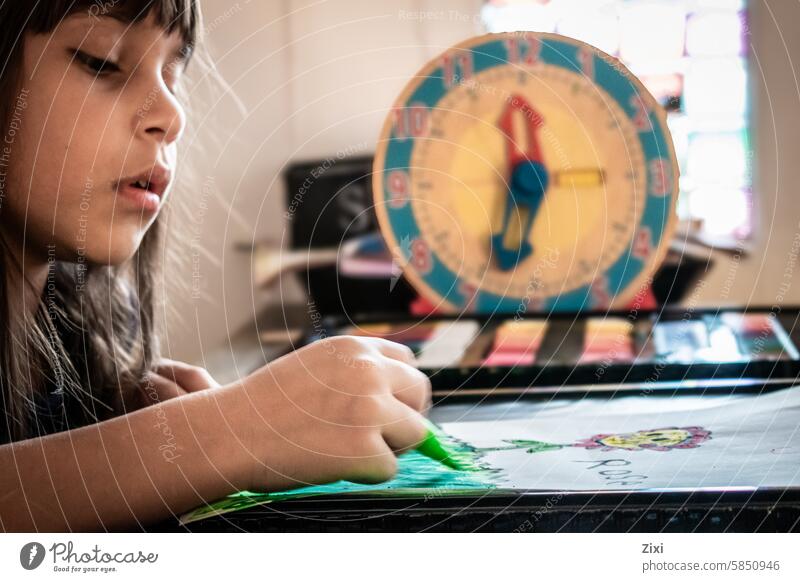 Child drawing child colors clock hand girl