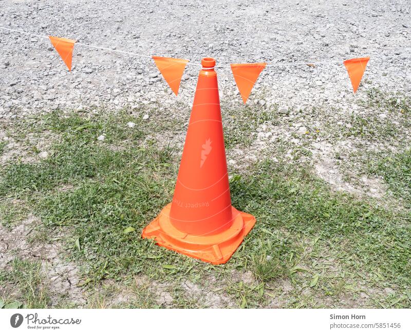 Orange pylon with pennants for marking and jumping off Pylon cordon Warn conspicuous Gaudy intense colour signal colour Safety Signs and labeling Barrier