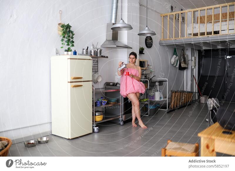 Morning routine in a modern loft kitchen woman pink dress eating yogurt vintage appliance style minimalism stylish interior young breakfast morning casual alone