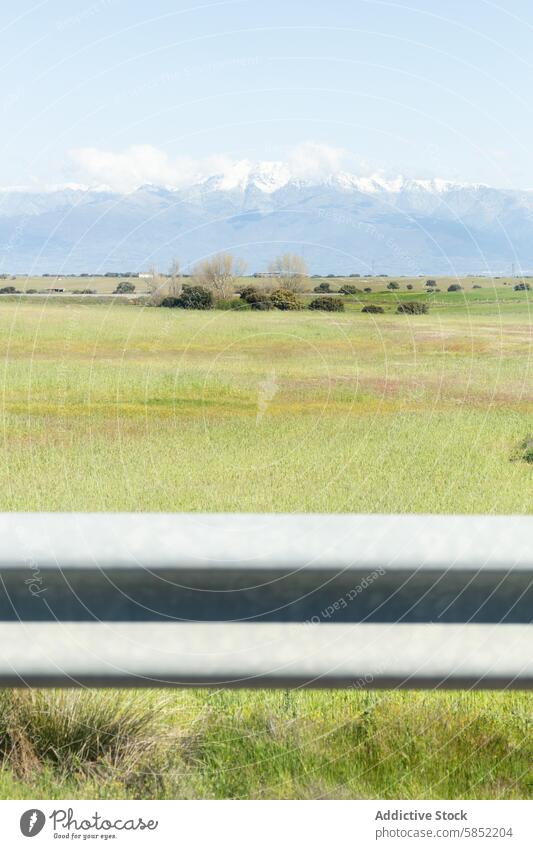 Guardrail view of a mountain range and meadow landscape guardrail nature snow-capped tranquil road scenic grassland field pasture rural countryside outdoor