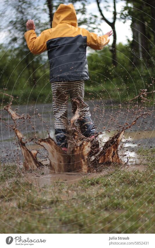 Fun in the giant puddle 2 Wet Summer Gravel path Meadow Joy fun muck about splashing Rubber boots Hop Rainwear Puddle Child slush pants Playing Jump Sludgy