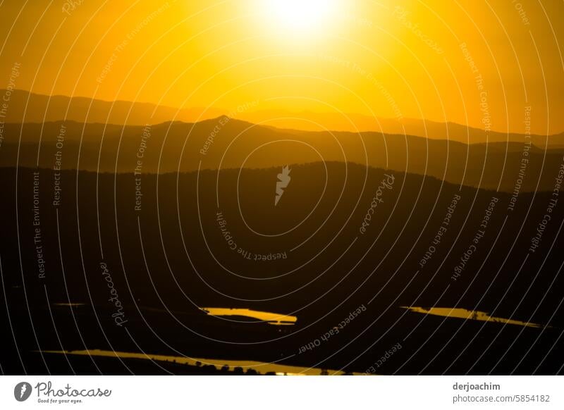 The evening sun shines over the mountains in a very intense orange color. Sunset Landscape Sunset sky Sunlight Sky evening mood Dusk Exterior shot Moody Horizon