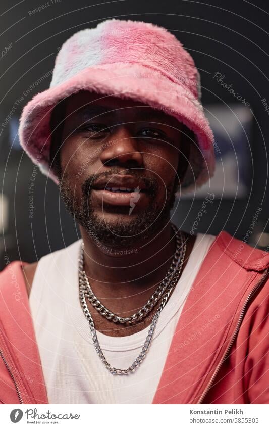 Black Man Wearing Pink Outfit Y2K Black man pink hip-hop rapper look at camera record video bucket hat influencer performer social media fuzzy fur trend y2k 90s