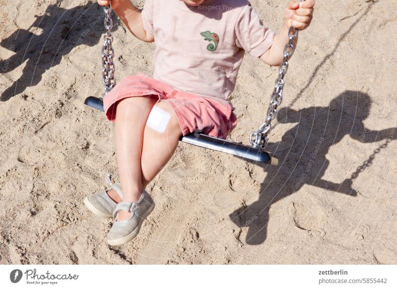 Grandson on the swing (with a plaster on his knee) chamissoplatz Only child Family holidays Child children's playground Toddler Light Sand Sandpit Shadow Swing