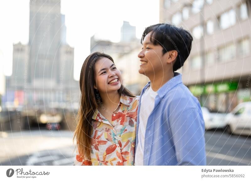 Happy young couple on a city street Asian real people fun enjoying young adult Authentic Cheerful Self-confident Woman Joy Millennia naturally portrait Positive