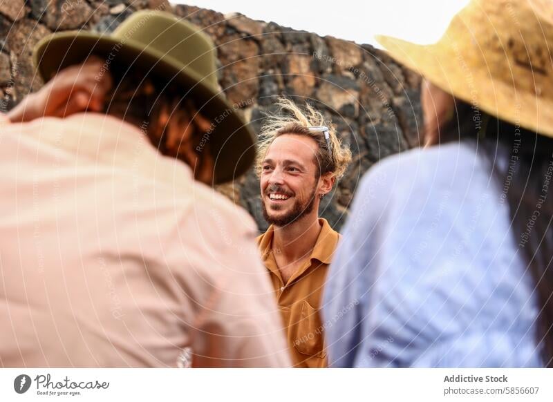 Smiling man outdoor with group of multiethnic friends at a barbecue party diverse men woman smiling laugh joy happiness caucasian social gathering summer