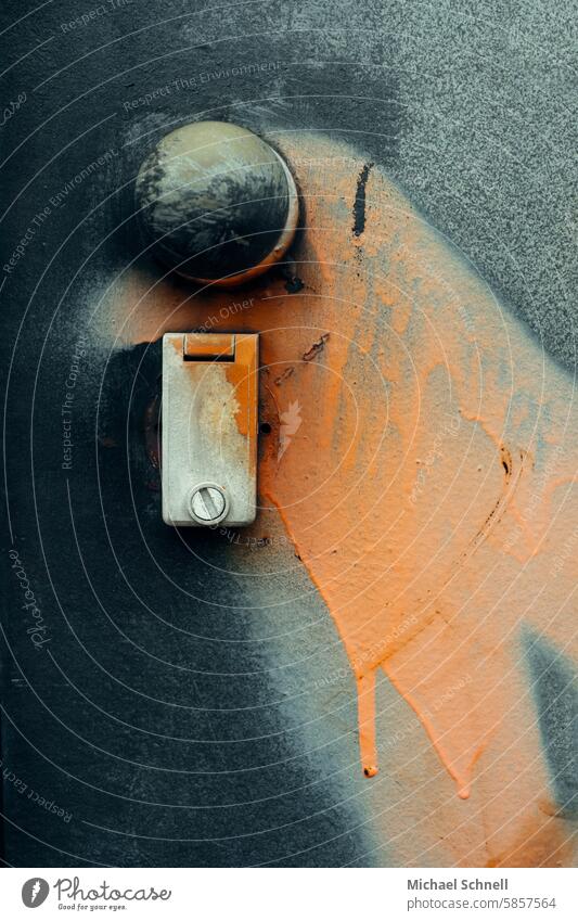 Paint daubed on a steel door Paint daubing Orange Daub Colour Entrance Lock fully lubricated Graffiti Closed