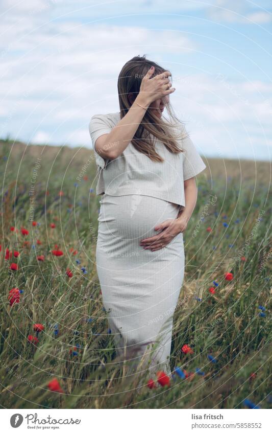 FLOWER MEADOW - WINDY - PREGNANCY Young woman pretty Pregnant pregnancy Flower meadow Poppy blossom Cornflower Grass Summer Nature Exterior shot Meadow Blossom