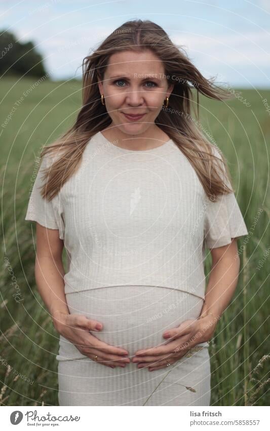 PREGNANCY - HOLDING THE BELLY - SPRING Woman 30 - 35 years long hairs Blonde Pregnant pregnancy Baby bump Modern naturally grasses Green Nature Feminine Wait