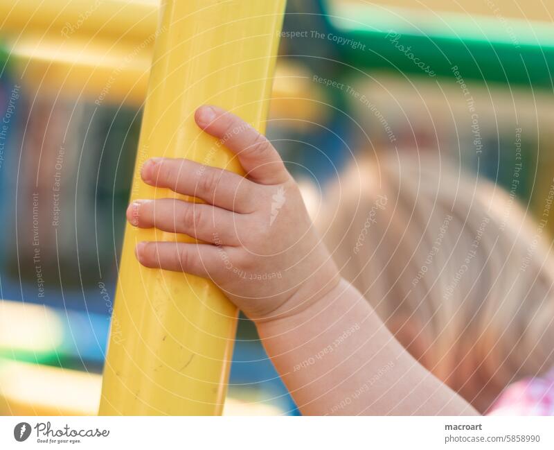 Hand of a small child on a yellow pole of a climbing frame Toddler kita Kindergarten nursery Fingers fingerche Girl Child Childlike Cute Diminutive Playing Romp