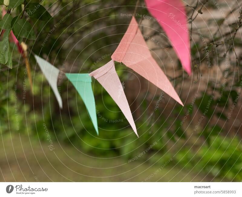 colorful pennant chain in pastel colors hanging outside celebration Party variegated triangles shape shaped geometric Figure pastel shades Green Pink pink